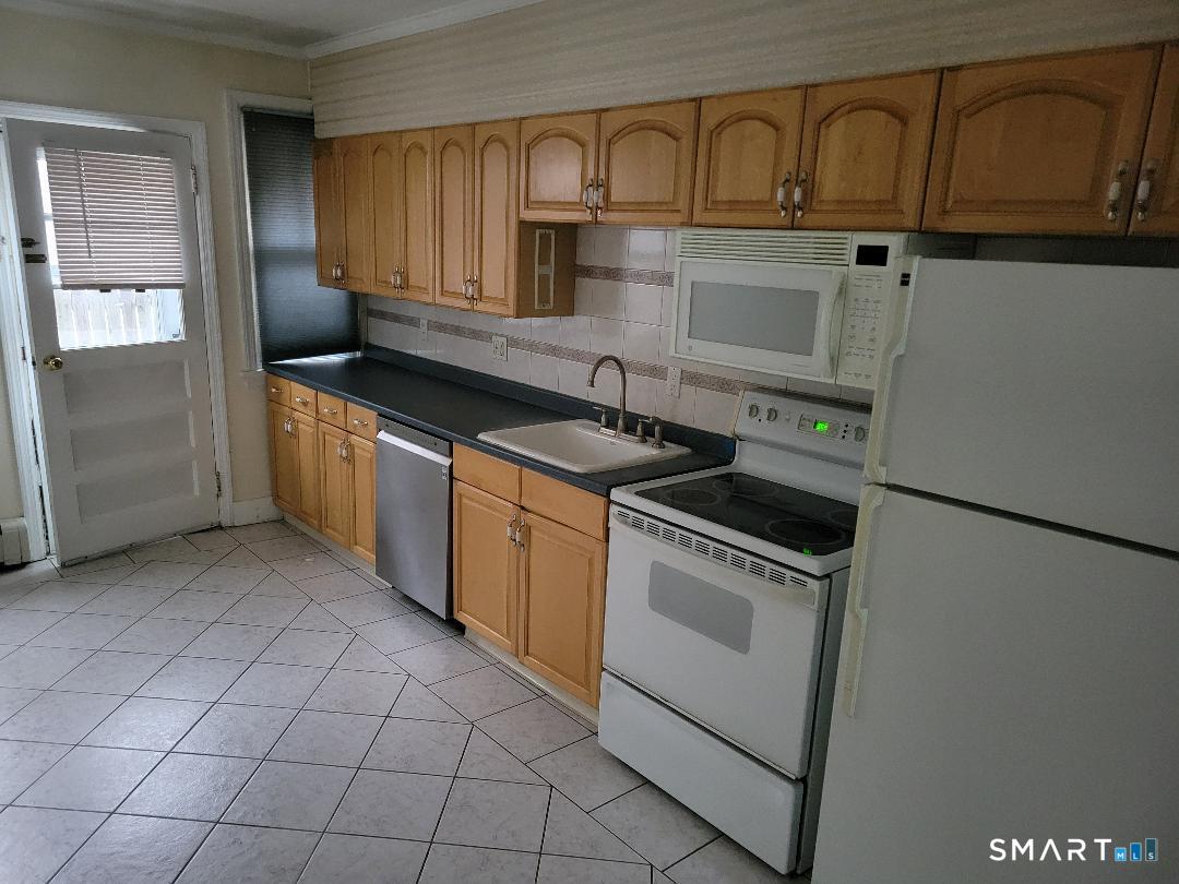 a kitchen that has a sink and a stove