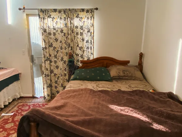 a bedroom with a bed and a window