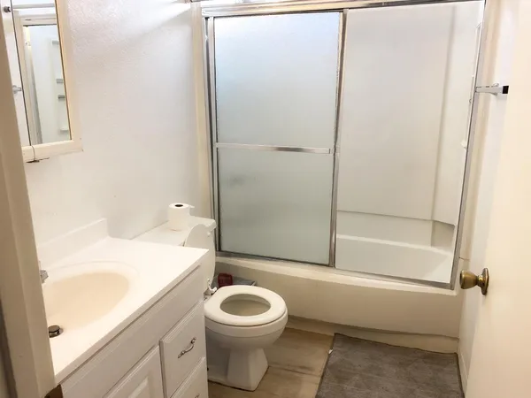 a bathroom with a toilet a sink and shower