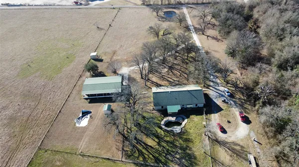 an aerial view of a house with a yard