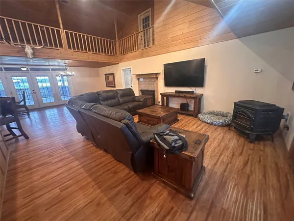 a spacious bedroom with a bed and dresser with mirror