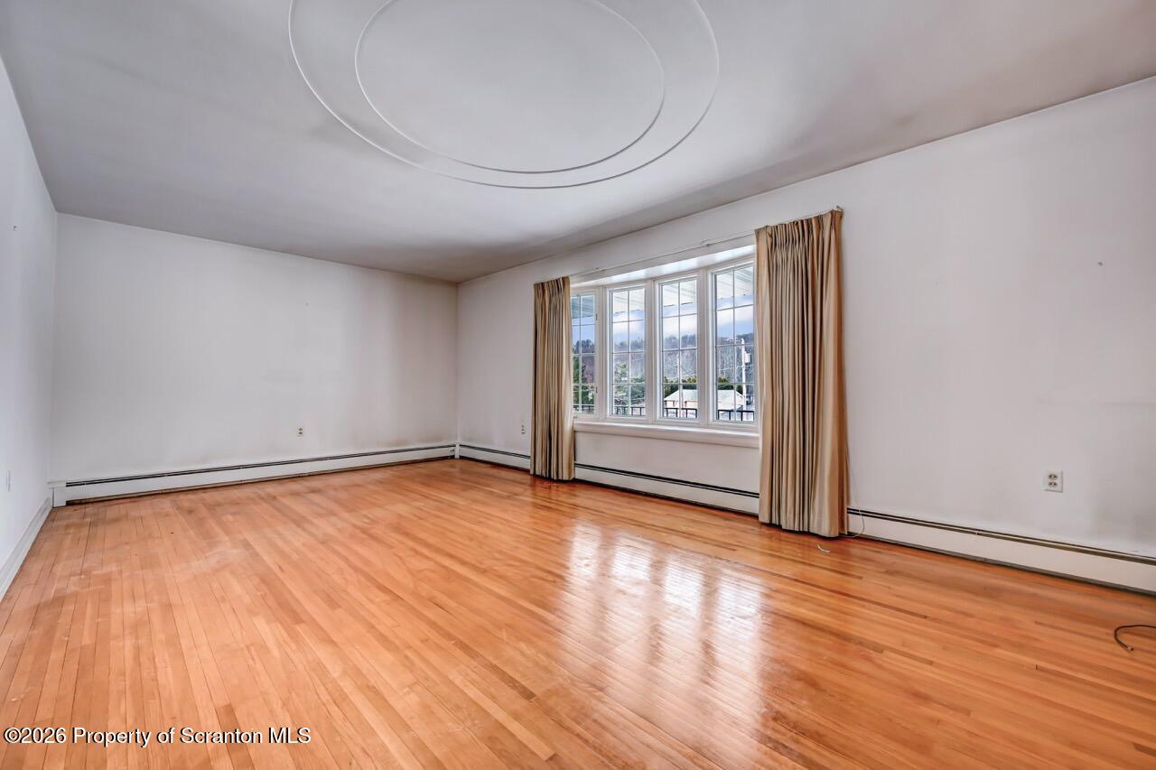 148 Green Grove Road Scott Township, PA 18447 - Photo 13 of 67 a view of an empty room with wooden floor and a window