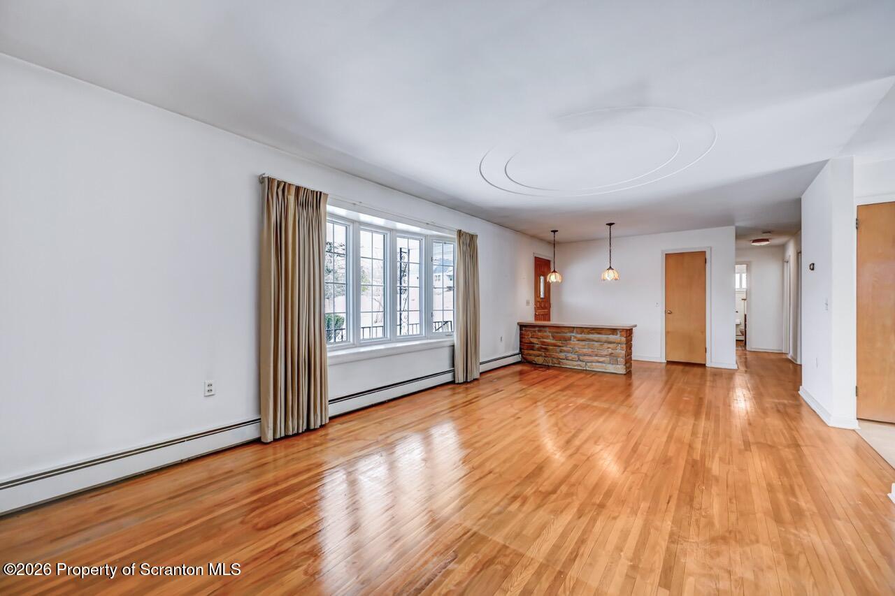 148 Green Grove Road Scott Township, PA 18447 - Photo 14 of 67 a view of empty room with wooden floor and fireplace