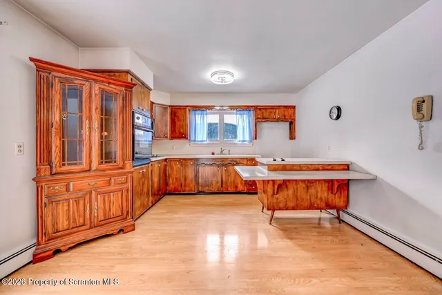 a view of room with window and wooden floor
