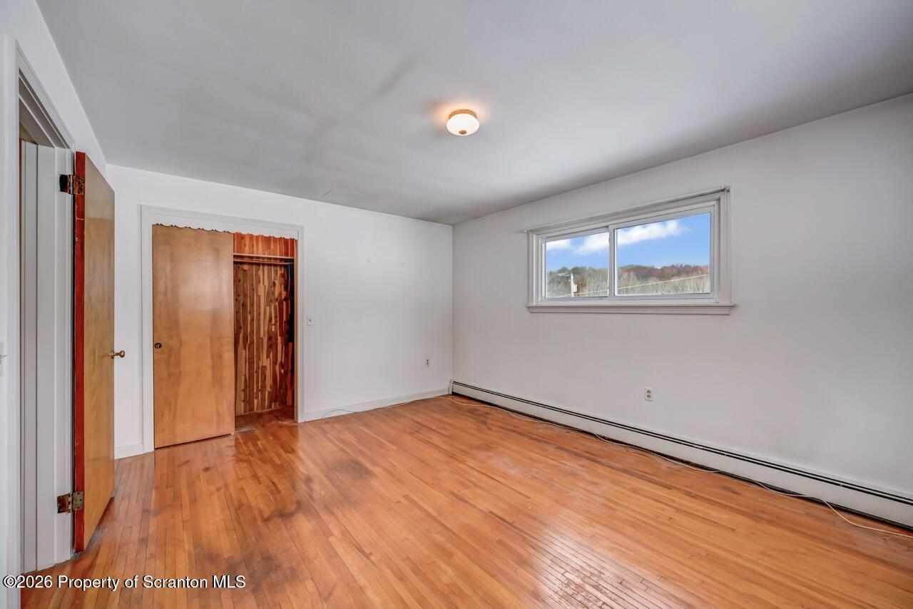 148 Green Grove Road Scott Township, PA 18447 - Photo 28 of 67 an empty room with wooden floor and windows