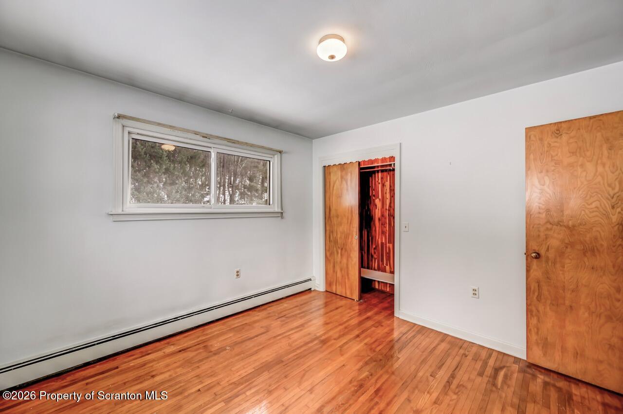 148 Green Grove Road Scott Township, PA 18447 - Photo 36 of 67 a view of an empty room with wooden floor and a window