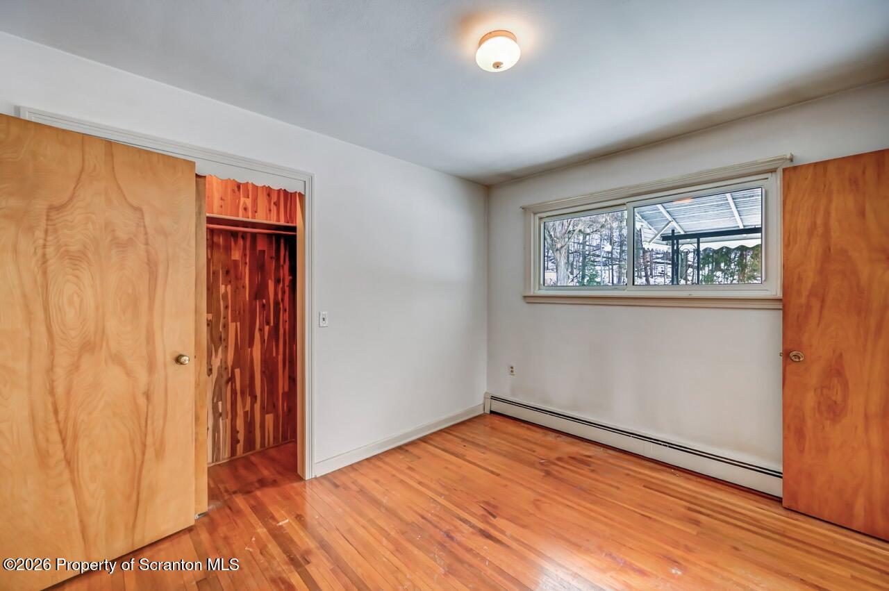 148 Green Grove Road Scott Township, PA 18447 - Photo 41 of 67 an empty room with wooden floor and windows