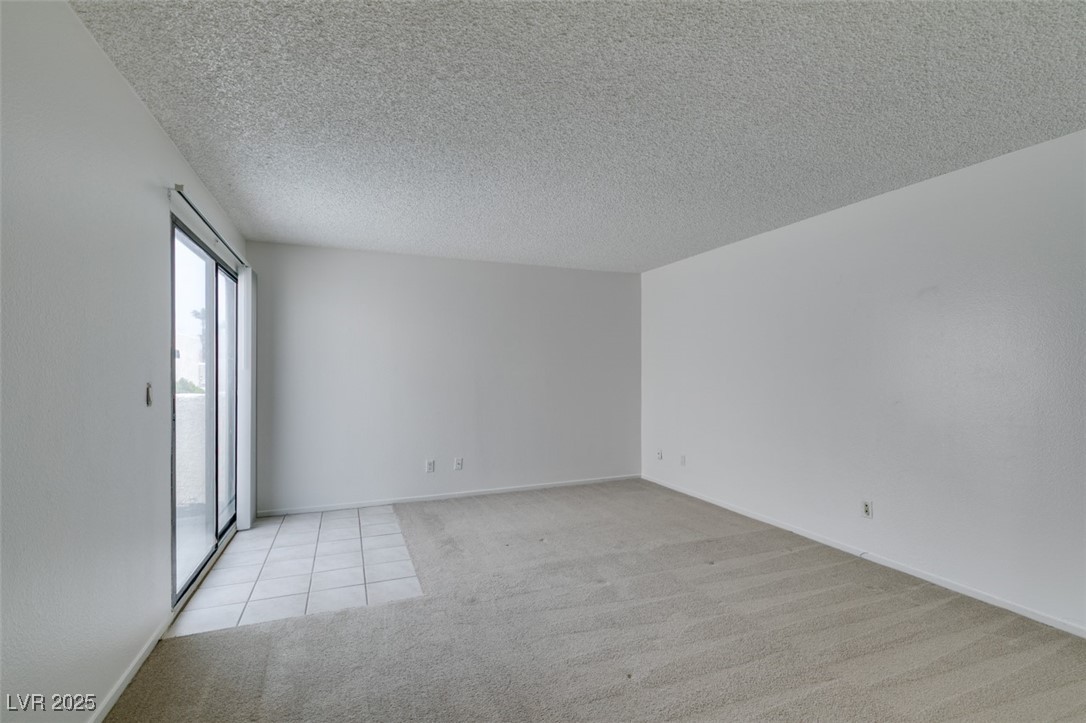 2681 Ruthe Duarte Avenue Las Vegas, NV 89121 - Photo 33 of 43 Spare room featuring light colored carpet and a textured ceiling