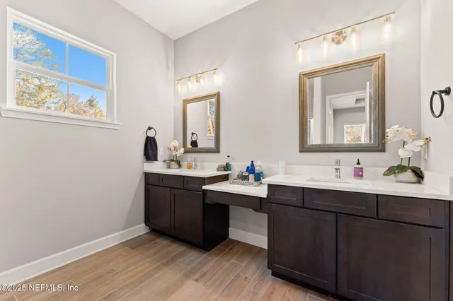 a kitchen with a sink cabinets and wooden floor