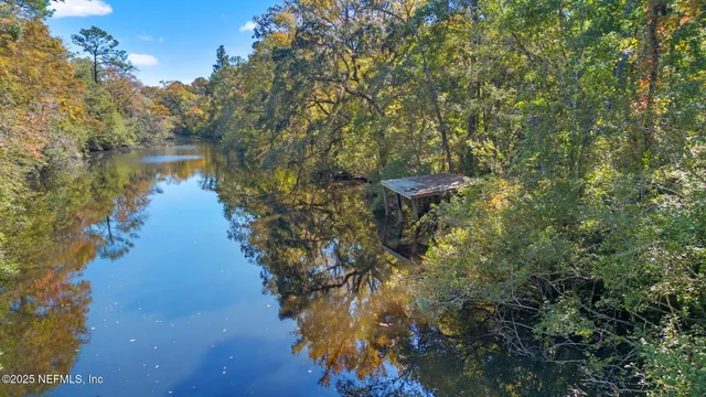 a view of a lake in between two of trees