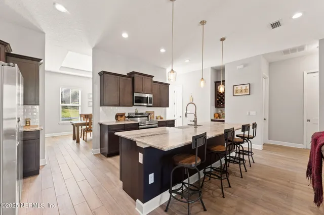a large kitchen with a table and chairs in it