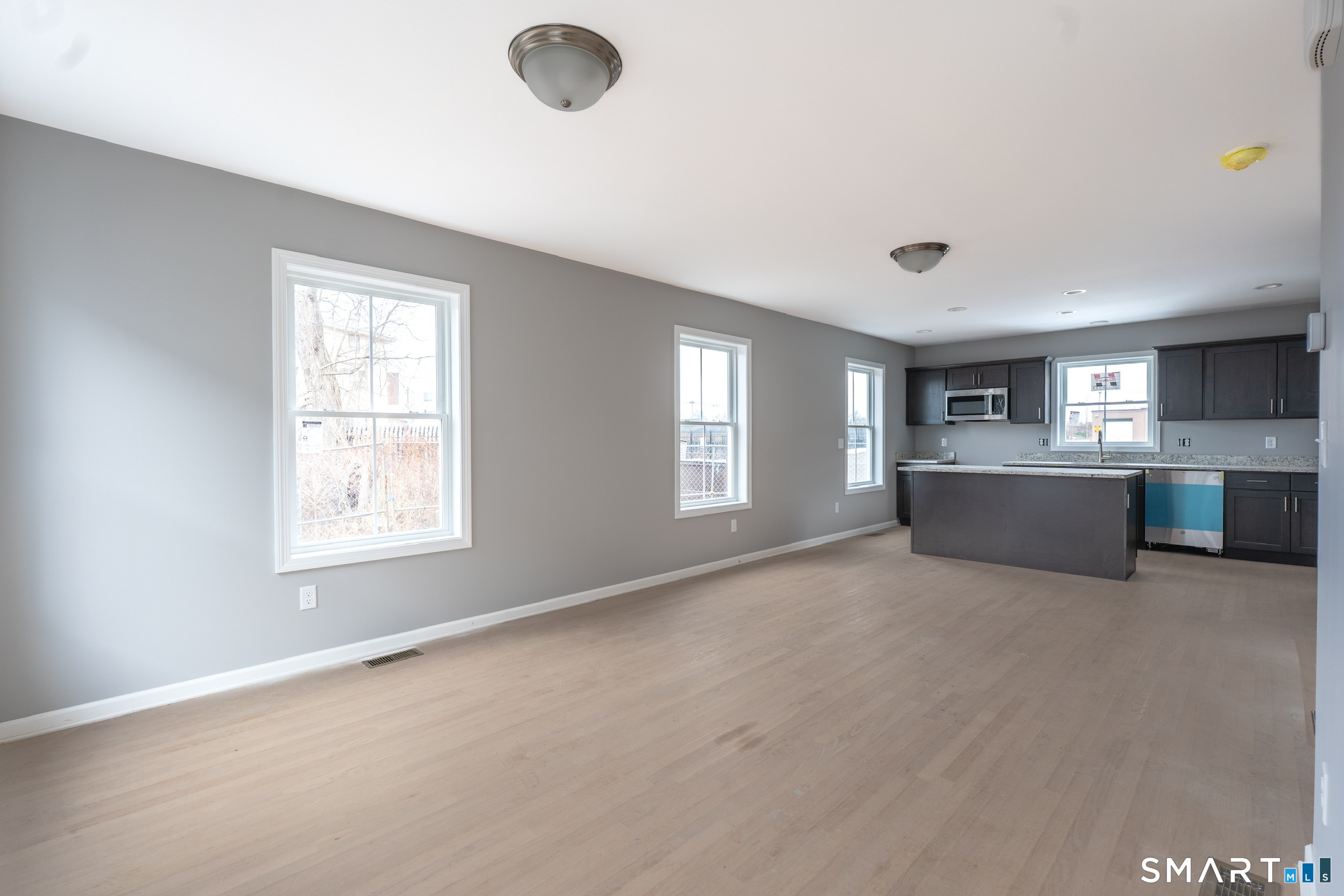 25 Hall Avenue Wallingford, CT 06492 - Photo 6 of 16 a view of an empty room with a window and kitchen view