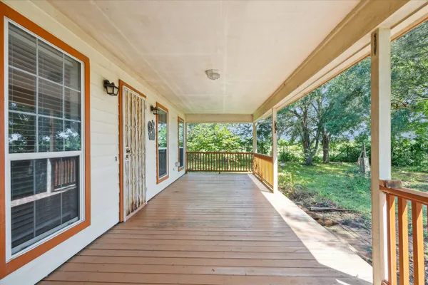 a view of a porch with wooden floor and outdoor space