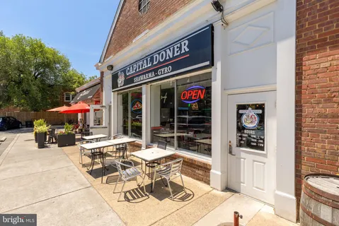 a view of a cafe with sitting area