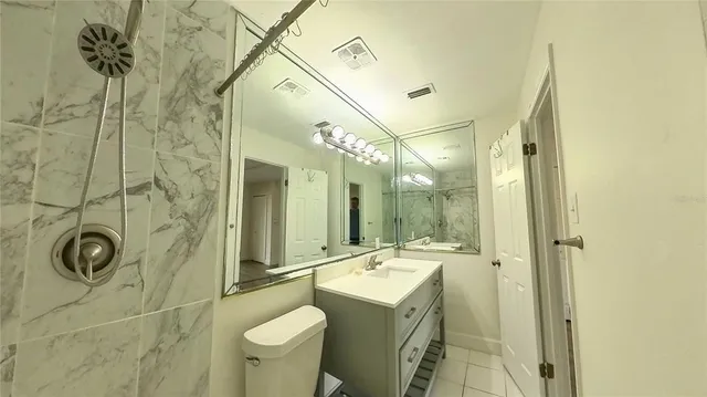 a bathroom with a shower sink and mirror