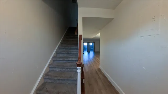a view of entryway and gallery with wooden floor