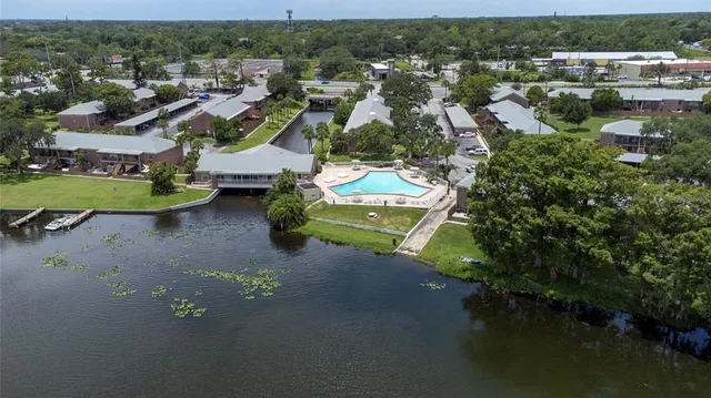 an aerial view of a house with a swimming pool yard and outdoor seating