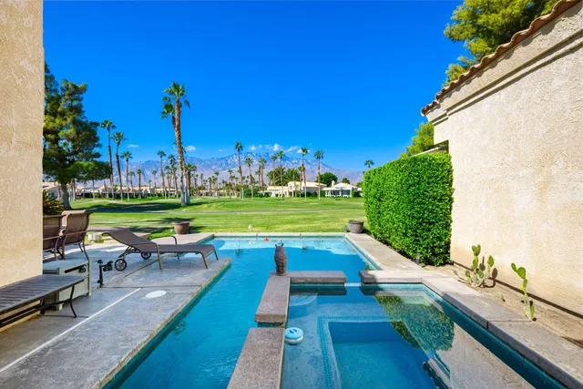 a view of a patio with table and chairs potted plants with wooden floor and fence