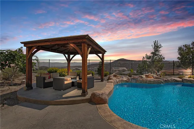 a view of swimming pool with outdoor seating and city view