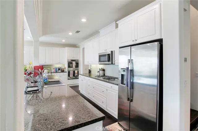 a dining room with furniture potted plants and wooden floor
