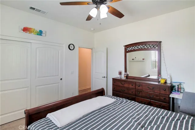 a bedroom with a bed and a desk