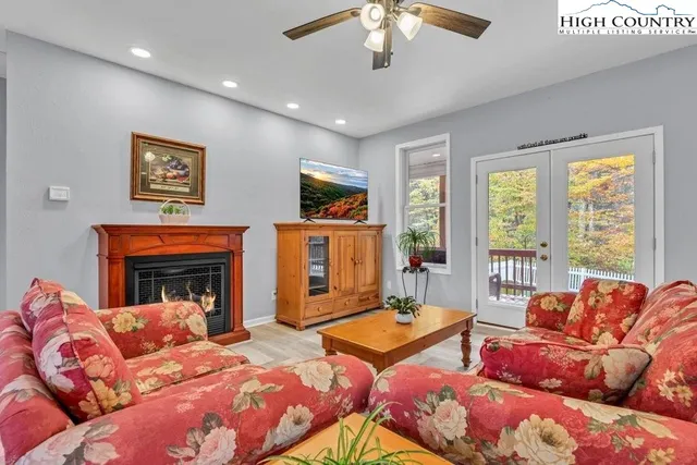 a living room with furniture and kitchen view