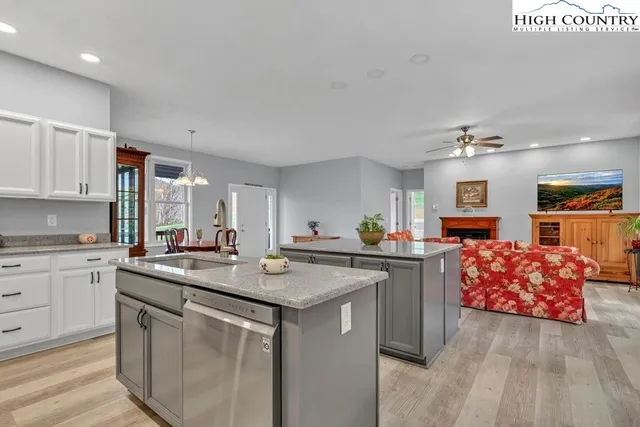 a kitchen with sink a microwave and cabinets