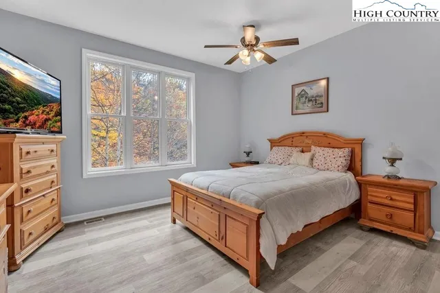 a bedroom with a bed dresser and a window