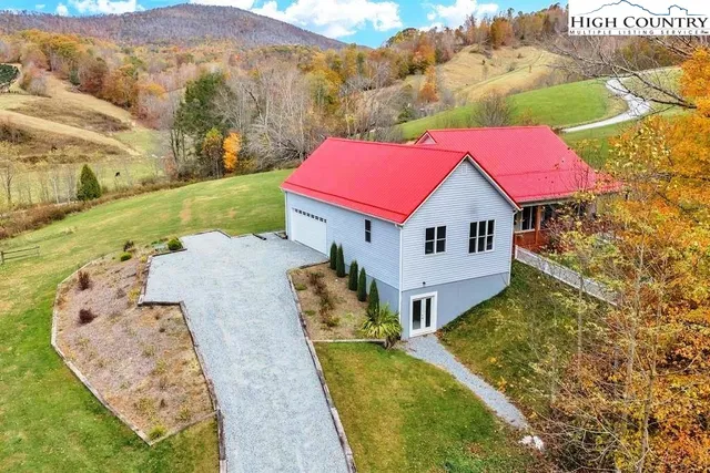 a aerial view of a house with a yard