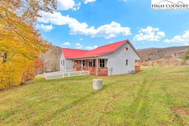 a view of a house with pool and a yard