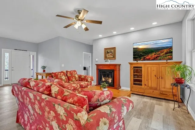 a living room with furniture fireplace and window