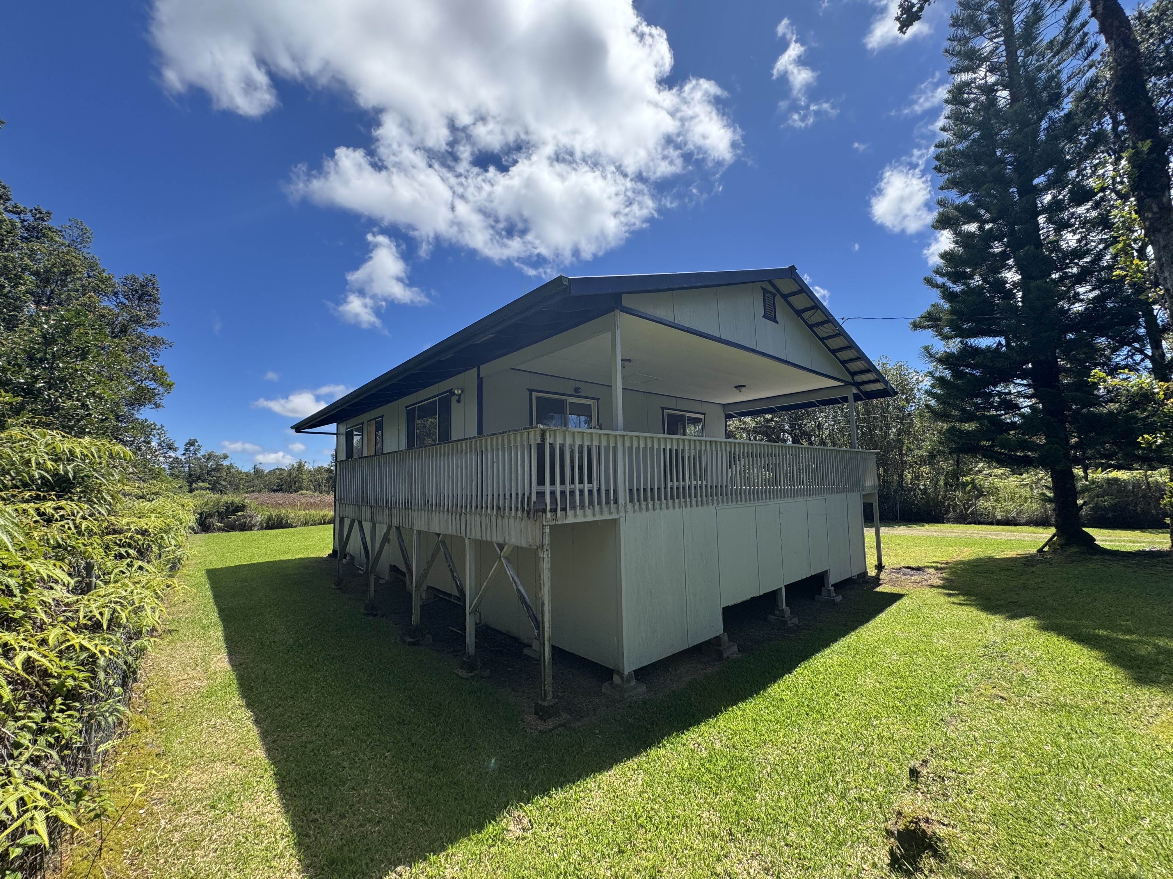 11-3132 Hibiscus Street Mountain View, HI 96771 - Photo 20 of 27 a view of a small house in the background