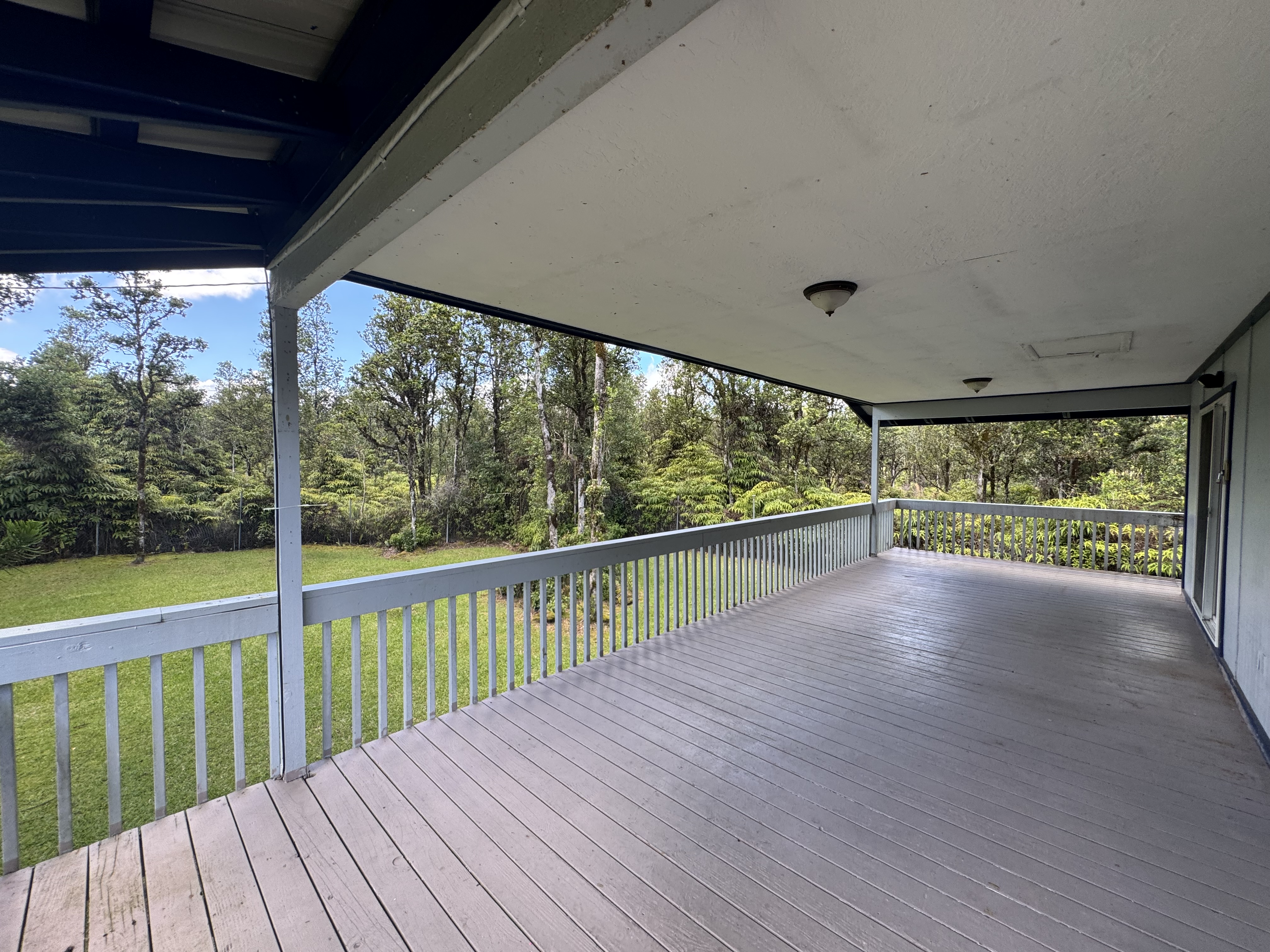 11-3132 Hibiscus Street Mountain View, HI 96771 - Photo 2 of 27 a view of a balcony with wooden floor