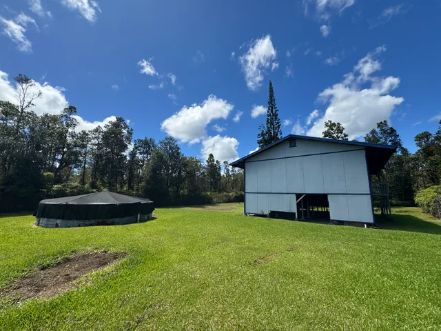 a view of a house with a backyard
