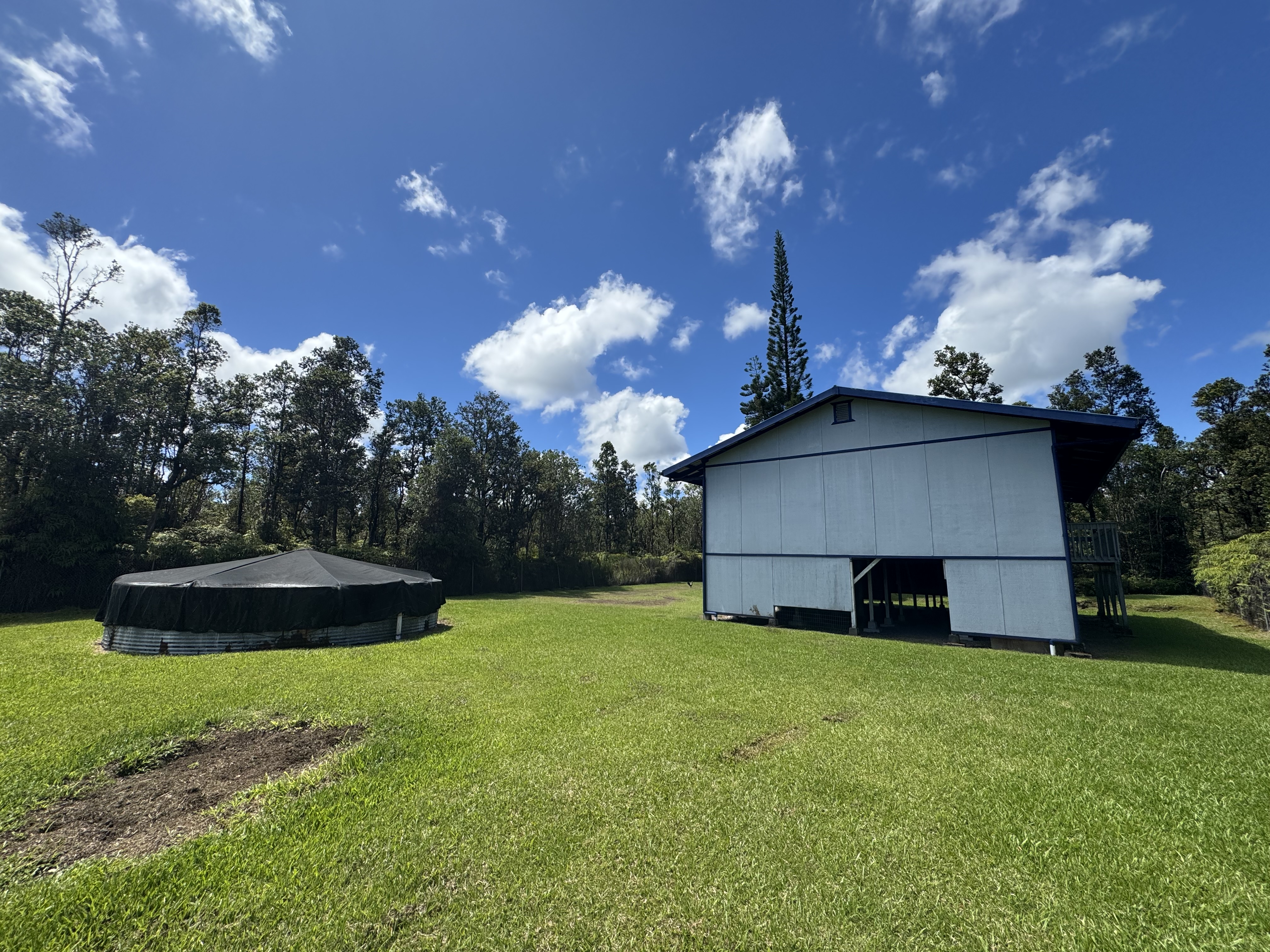 11-3132 Hibiscus Street Mountain View, HI 96771 - Photo 21 of 27 a view of a house with a backyard