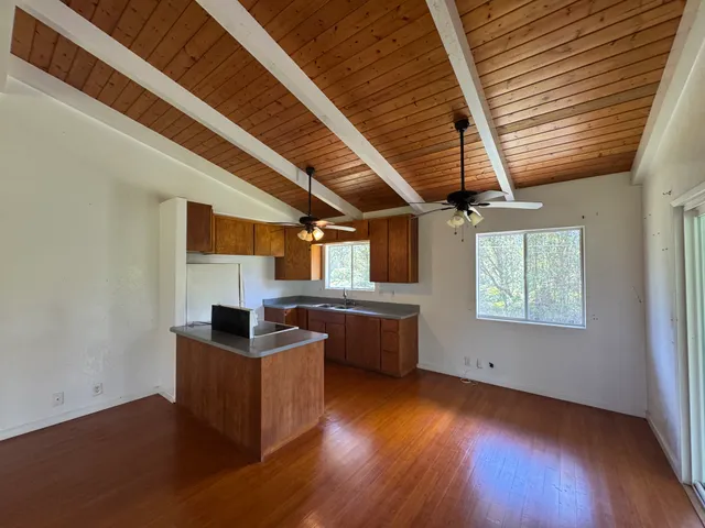a view of a kitchen with furniture and wooden floor