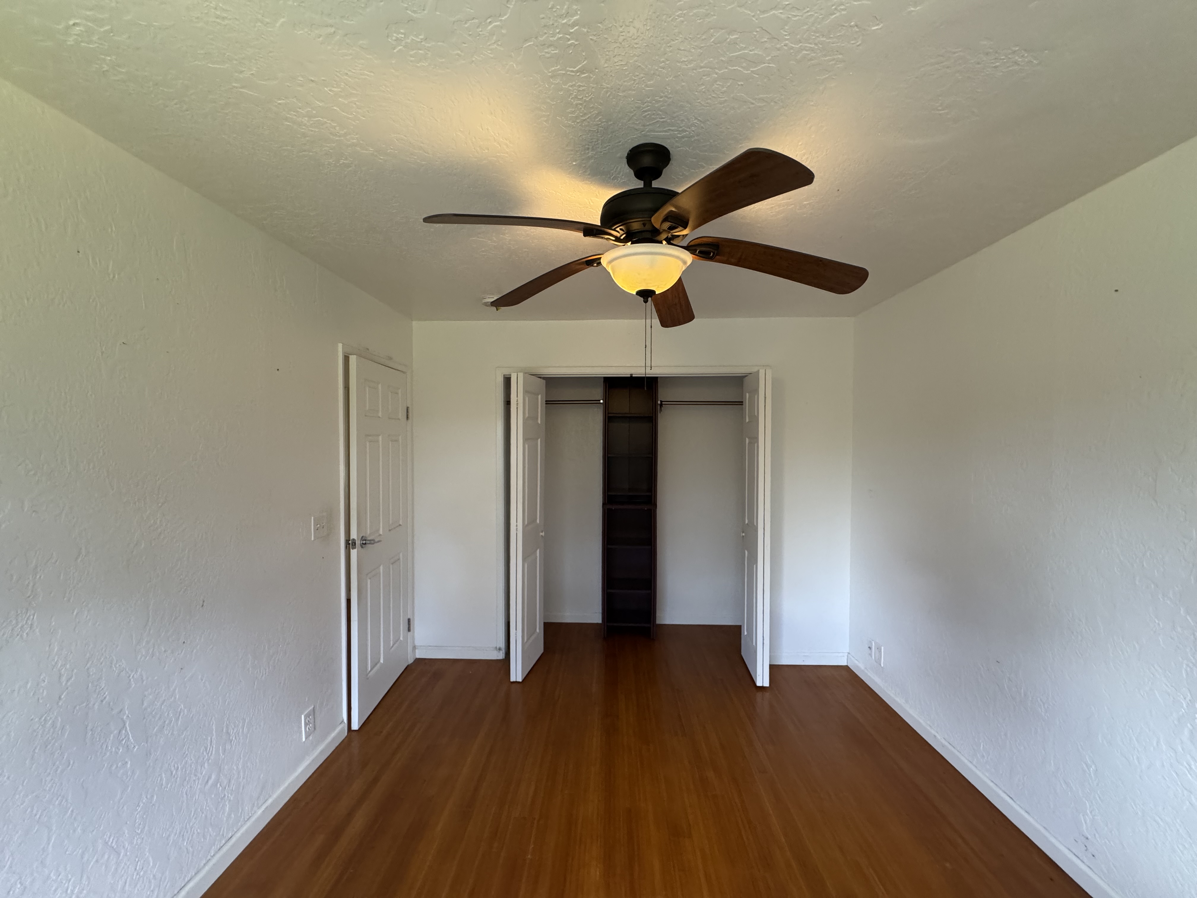 11-3132 Hibiscus Street Mountain View, HI 96771 - Photo 8 of 27 a view of an empty room with wooden floor