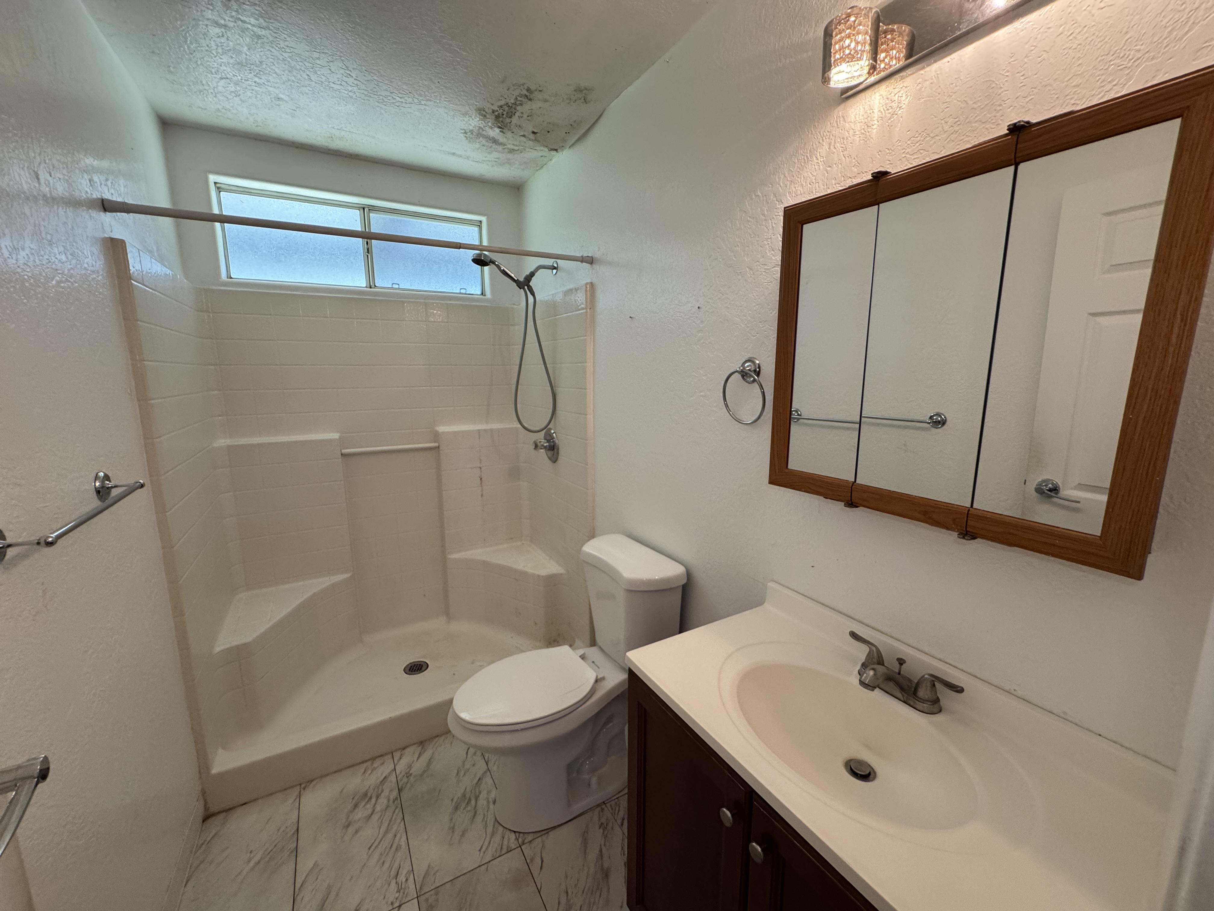 11-3132 Hibiscus Street Mountain View, HI 96771 - Photo 9 of 27 a bathroom with a sink a toilet and shower