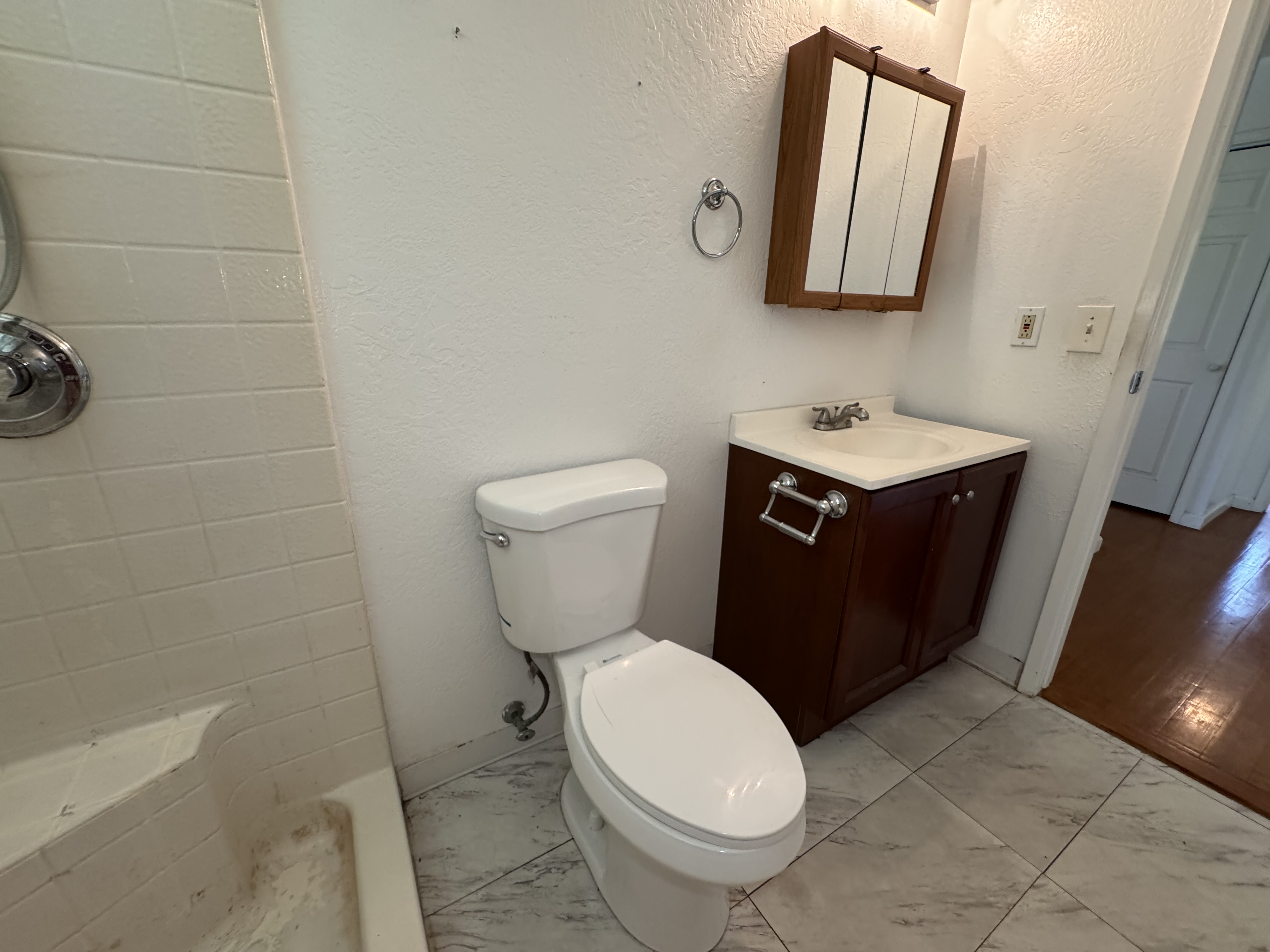11-3132 Hibiscus Street Mountain View, HI 96771 - Photo 10 of 27 a bathroom with a toilet a sink and mirror
