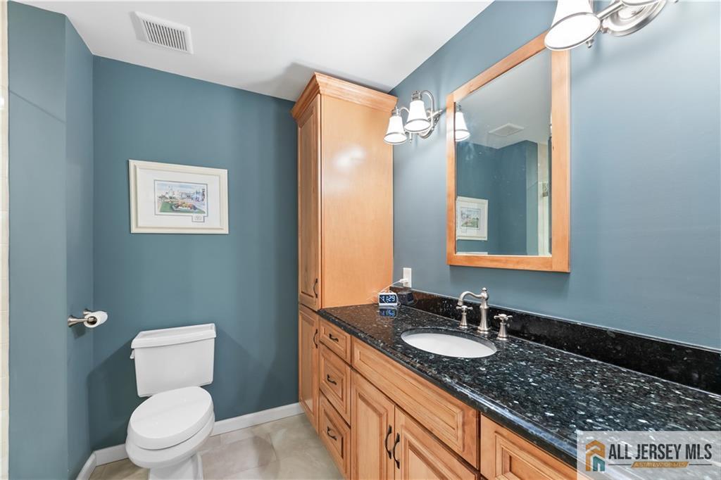 28 Garfield Way Princeton, NJ 08540 - Photo 5 of 39 a bathroom with a granite countertop sink toilet and mirror