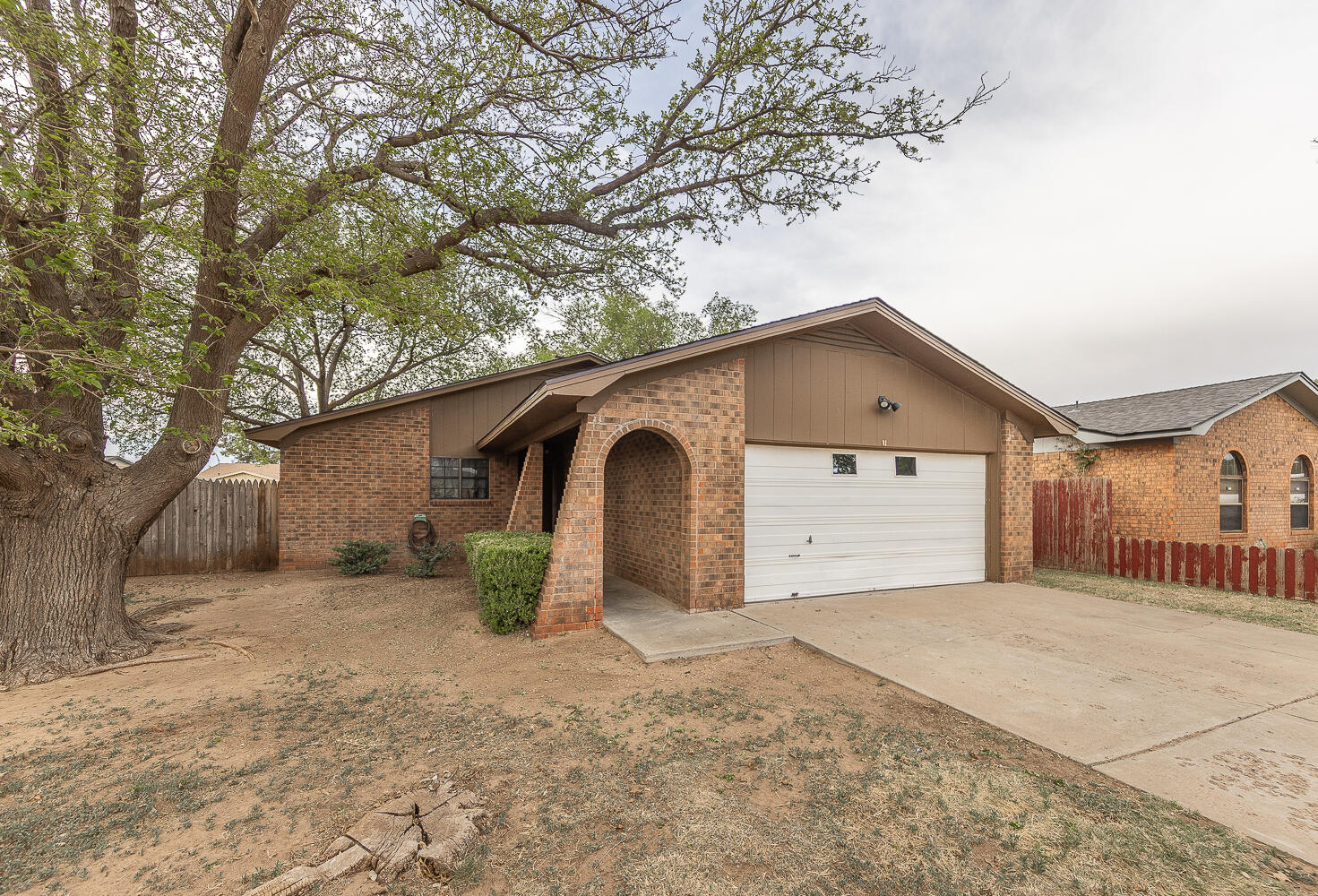 6305 35th Street Lubbock, TX 79407 - Photo 12 of 20 a view of a house with a yard and garage