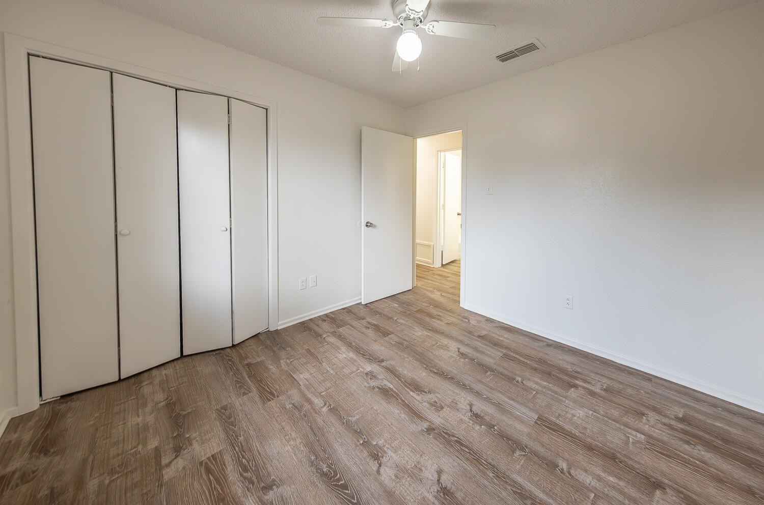 6305 35th Street Lubbock, TX 79407 - Photo 13 of 20 a view of an empty room with wooden floor