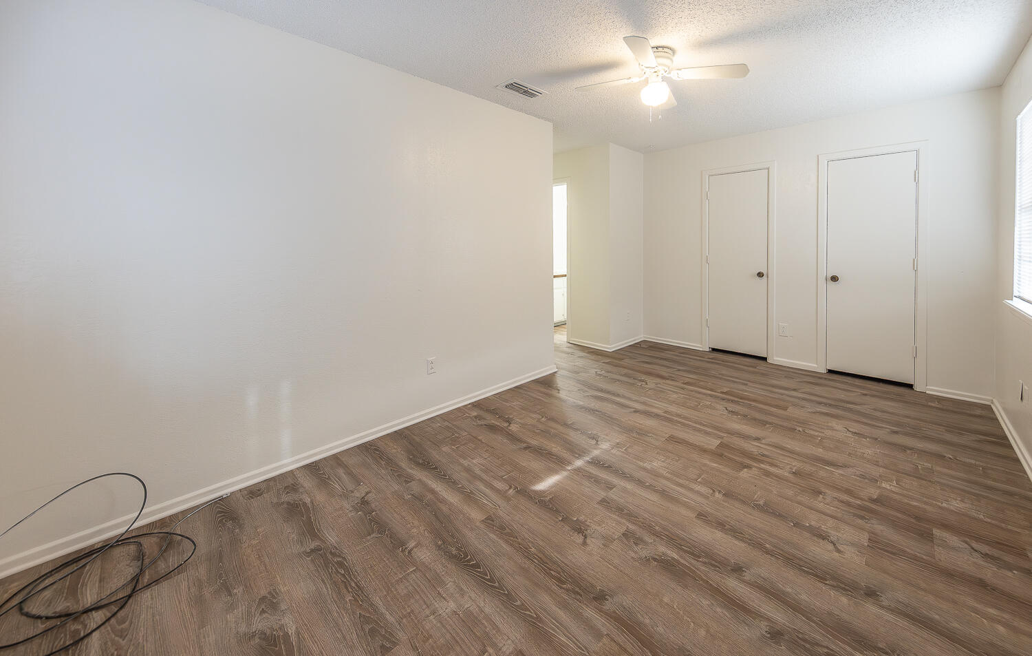 6305 35th Street Lubbock, TX 79407 - Photo 15 of 20 a view of an empty room with wooden floor