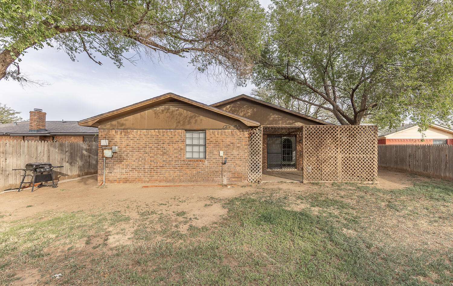 6305 35th Street Lubbock, TX 79407 - Photo 18 of 20 a front view of house with yard and trees in the background