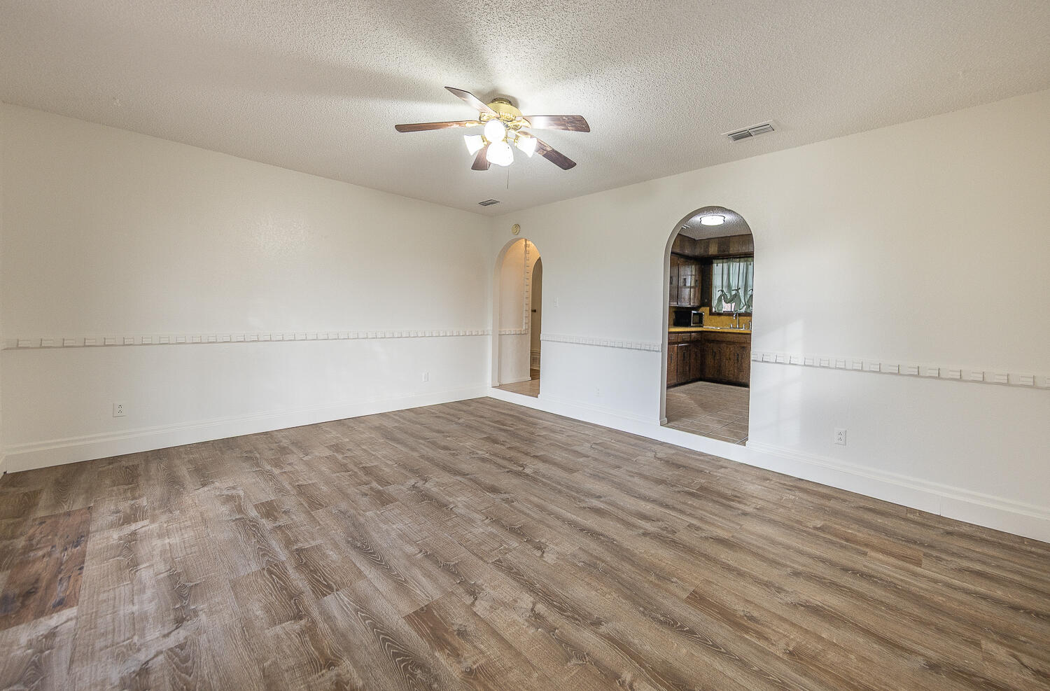 6305 35th Street Lubbock, TX 79407 - Photo 2 of 20 a view of empty room with wooden floor