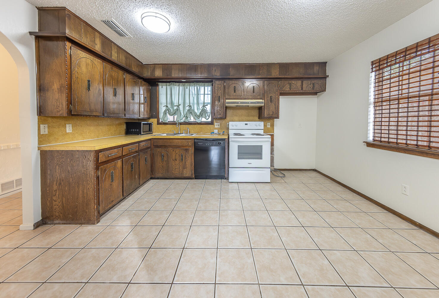 6305 35th Street Lubbock, TX 79407 - Photo 3 of 20 a kitchen with stainless steel appliances granite countertop a sink stove and cabinets