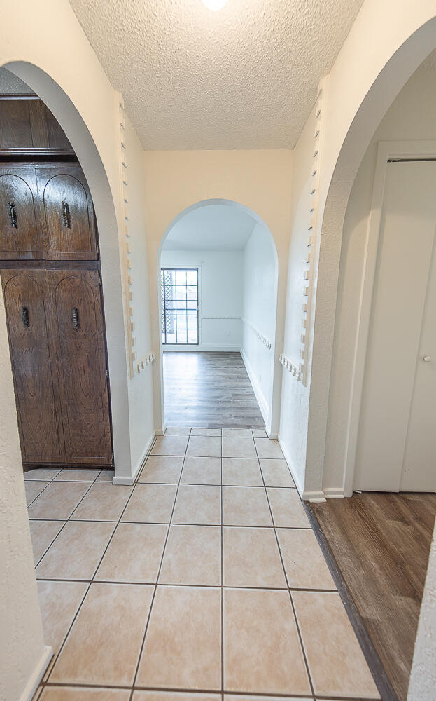 6305 35th Street Lubbock, TX 79407 - Photo 5 of 20 a view of a hallway with wooden floor and a living room