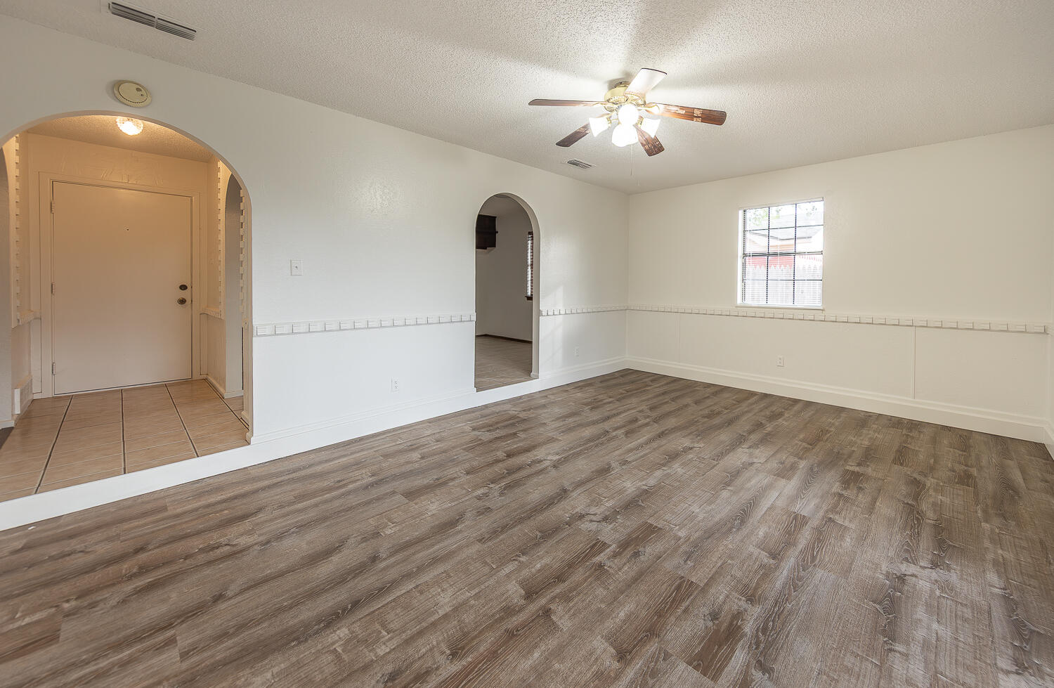6305 35th Street Lubbock, TX 79407 - Photo 6 of 20 a view of empty room with wooden floor