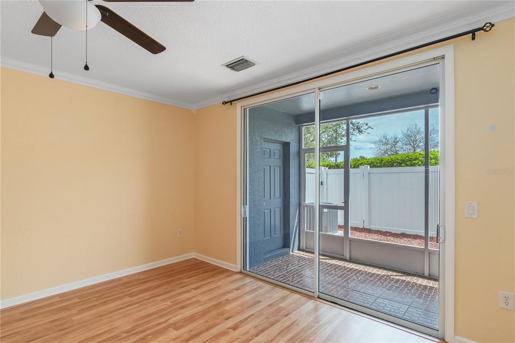 4814 Southwest 44th Circle Ocala, FL 34474 - Photo 14 of 40 a view of an empty room with wooden floor and a window