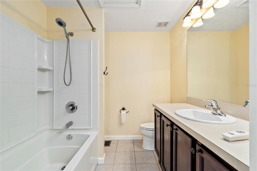 4814 Southwest 44th Circle Ocala, FL 34474 - Photo 25 of 40 a bathroom with a tub sink mirror and a shower